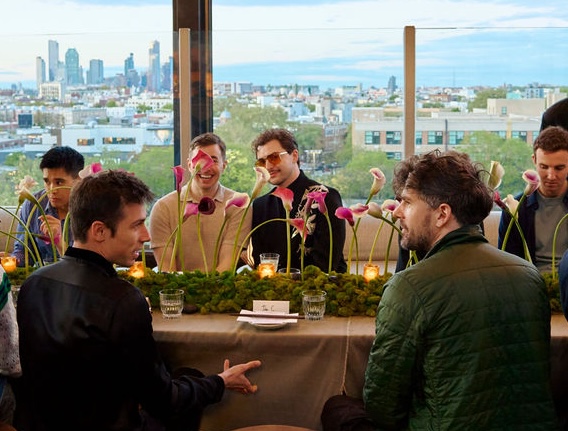 Sector Supper Club table with calla-lily centerpiece and skyline view