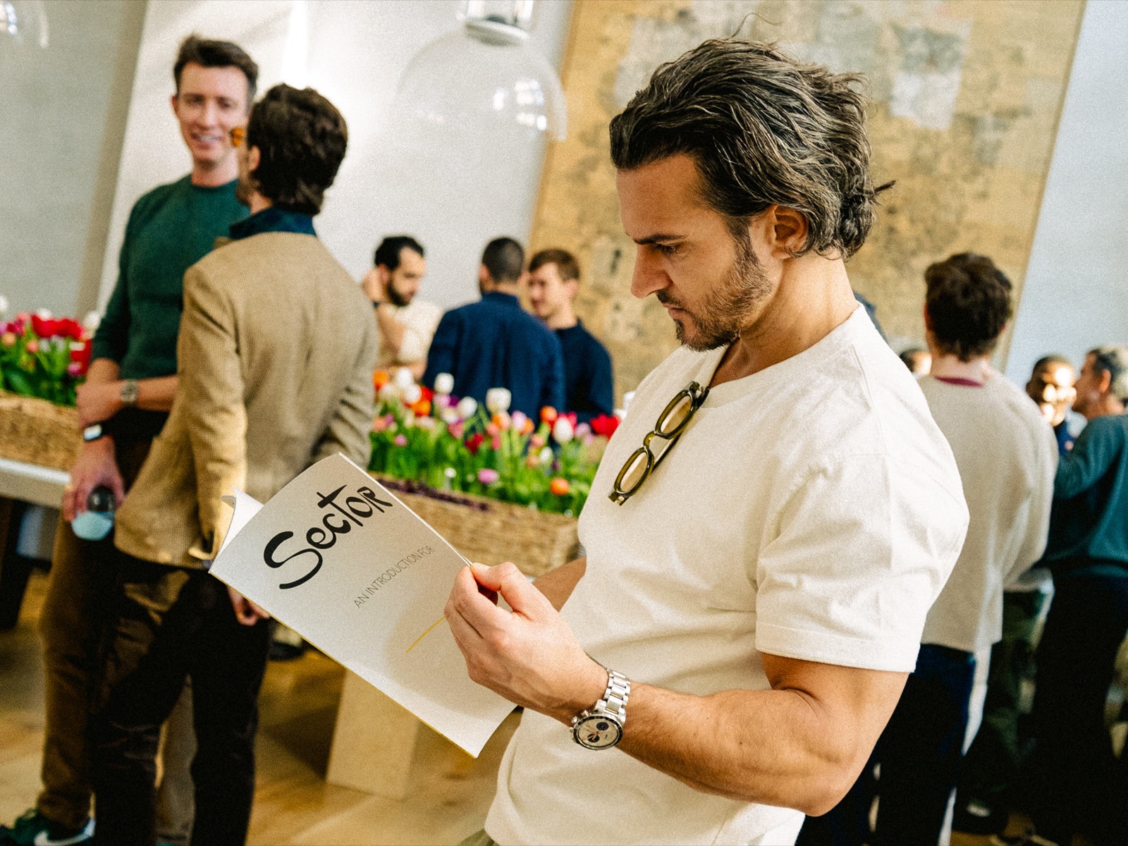 Sector members at a Sector event reading the Sector booklet