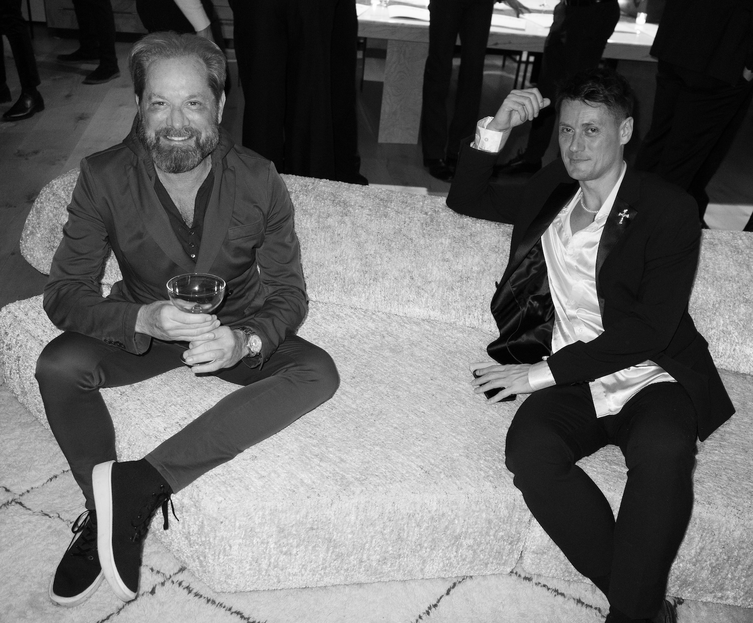 Two Sector members in conversation on a sofa